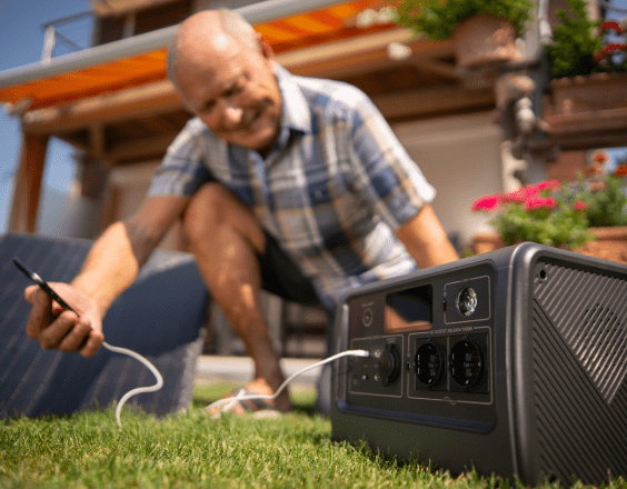 A man beside a portable battery which is best suited for power on the go