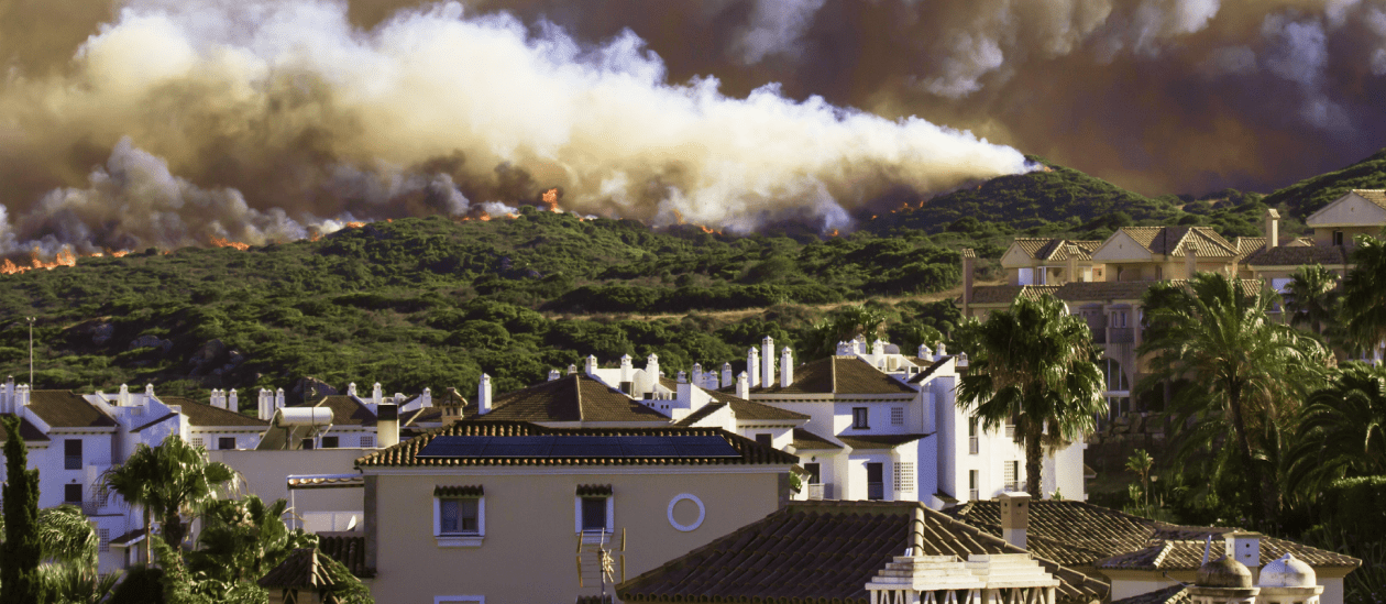 Wildfire smoke and debris descending on a residential area