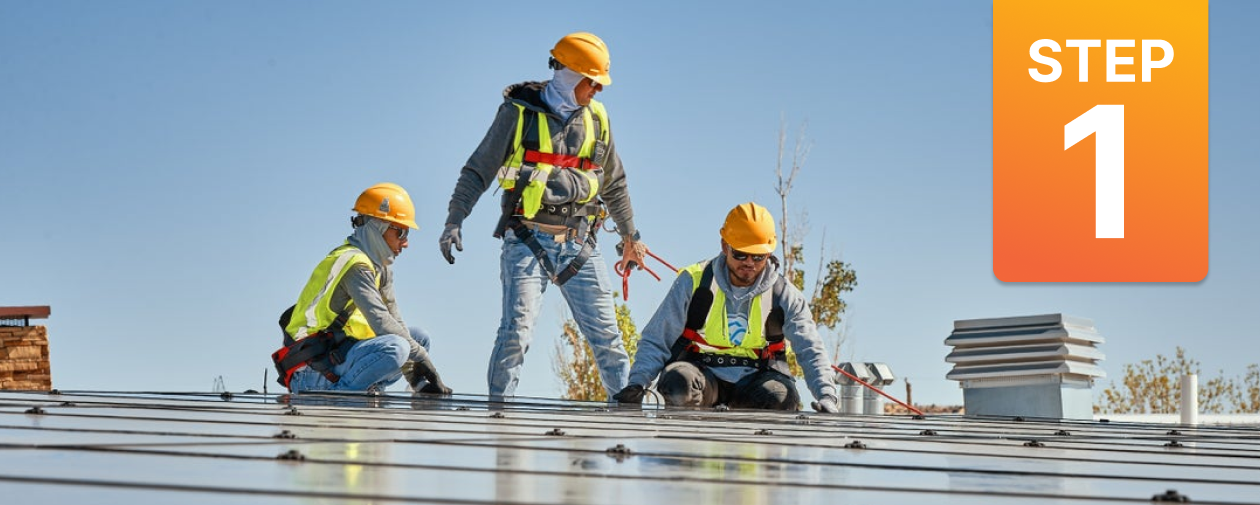 Contractors installing Solar panels on a school