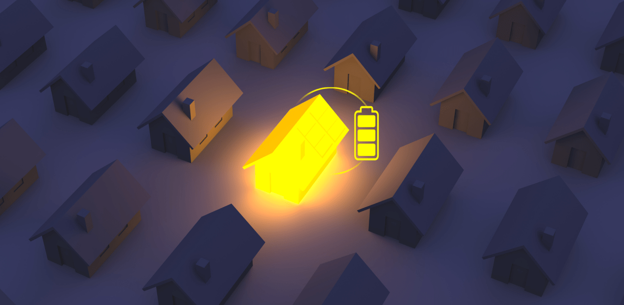 houses in the dark with one glowing in the center